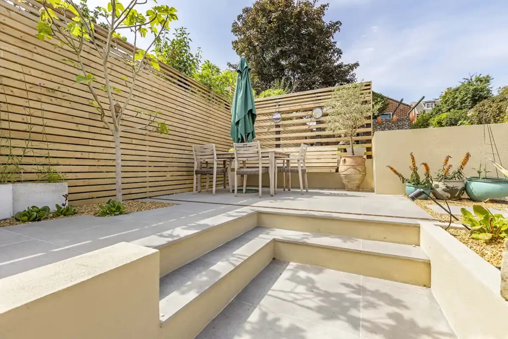Landscaped garden in Norwich with Porcelain tiles and a floating bench.