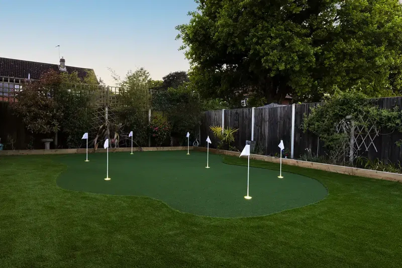 Artificial grass installed in this Norwich garden by Landscapers Acorn to Oak