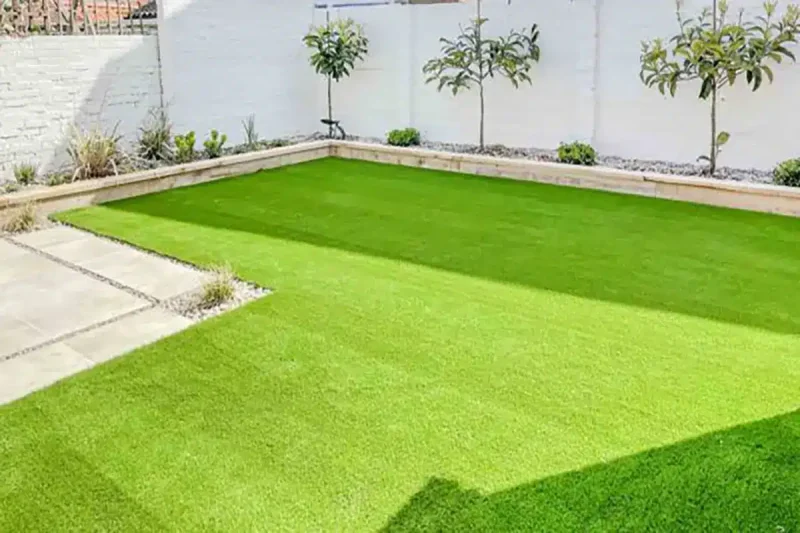 Artificial turf installed at this Norwich garden by Landscapers Acorn to Oak